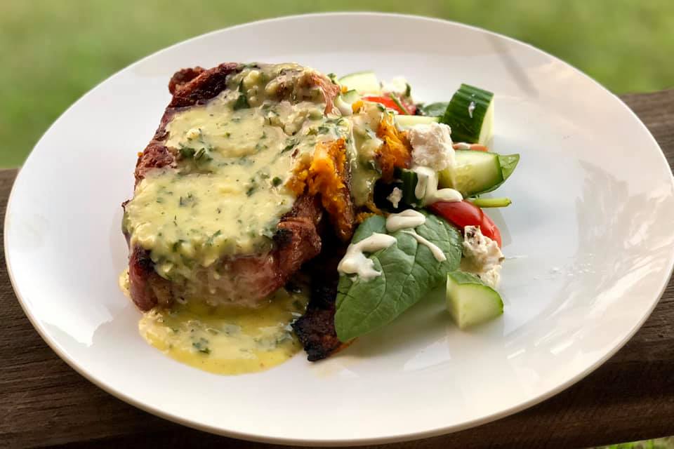 Creamy garlic sauce on steak with salad