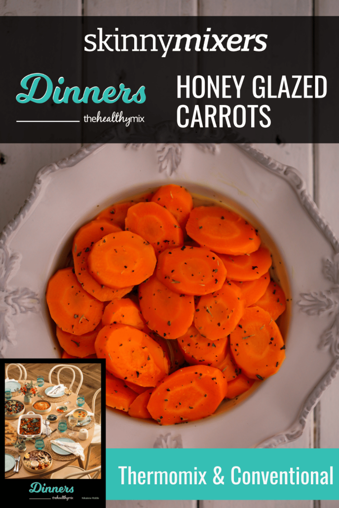 Honey Glazed Carrots in a white bowl with French Spice Mix on top